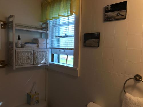 a bathroom with a sink, toilet and window at Cedar Ridge Cabins in Honor