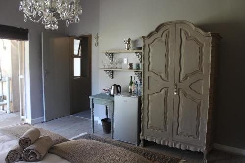 a bedroom with a large cabinet and a table at 35 on Basil in Caledon