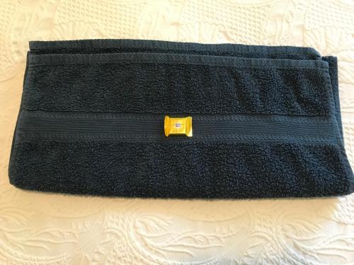 a black clutch bag with a yellow zipper at Chata Rosa in Malenovice
