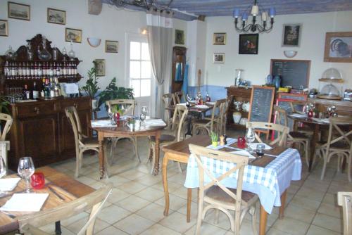a restaurant with tables and chairs in a room at Logis Cote Loire - Auberge Ligerienne in Blois