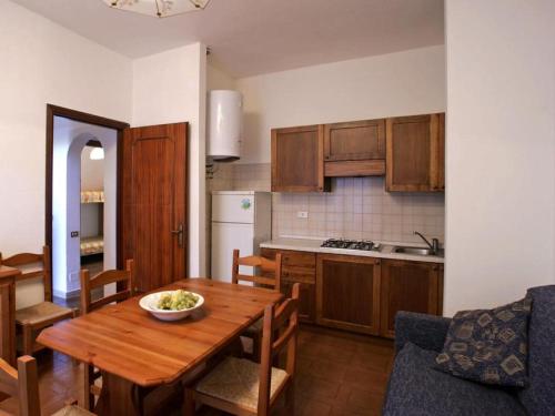 a kitchen and dining room with a wooden table at Giannella Appartamenti in Orbetello