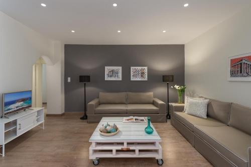 a living room with a couch and a coffee table at Mythos Residence in Rethymno