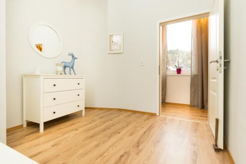 a room with a dresser and a mirror on a dresser at Ferienwohnungen am Markt in Bad Grund