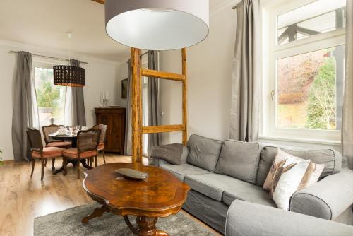 a living room with a couch and a table at Ferienwohnungen am Markt in Bad Grund