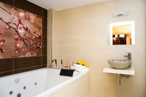 a bathroom with a tub and a sink at Casa Grimalt in Jalón