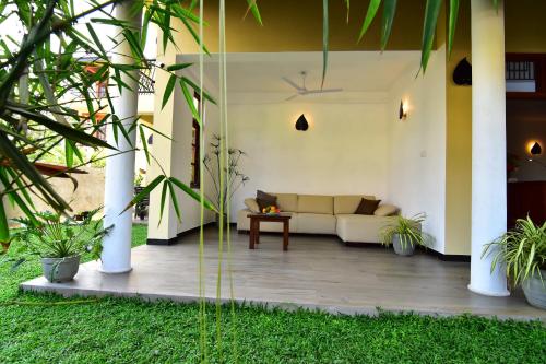 a living room with a couch on a patio at Park Lane Apartments in Negombo
