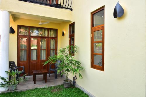 a front porch of a house with a wooden door at Park Lane Apartments in Negombo