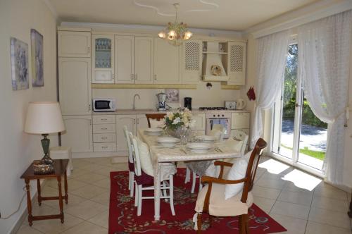 a kitchen with a table and chairs and a table and a table at Casa Eleganza in Tremezzo