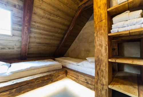 a room with two beds in a wooden cabin at Aparthotel & Wellness Knížecí cesta in Horní Planá