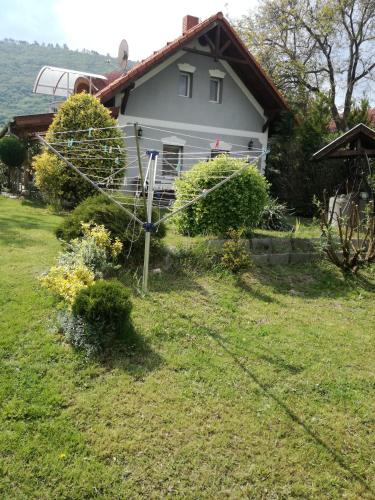 a white house with a yard with at Margó Nyaraló in Balatonederics