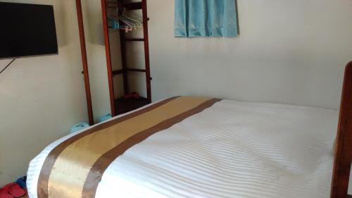 Cama en habitación con sábanas blancas en Sunny's Home en Jincheng