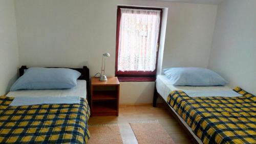 a bedroom with two beds and a window at Jakišnica Apartment in Lun