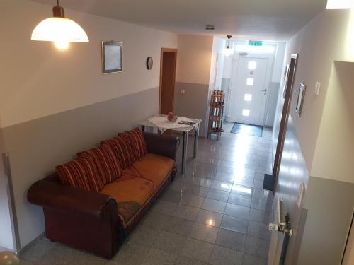 a living room with a couch and a table at Pension Lindengarten in Nürnberg