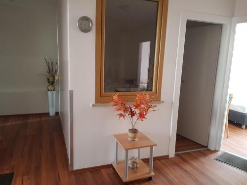 a room with a vase with flowers on a table at Pension Lindengarten in Nürnberg