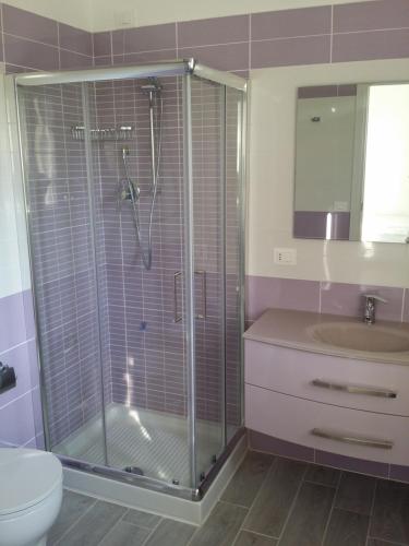 a bathroom with a shower and a toilet and a sink at Le Castella B&B Restaurant in Le Castella