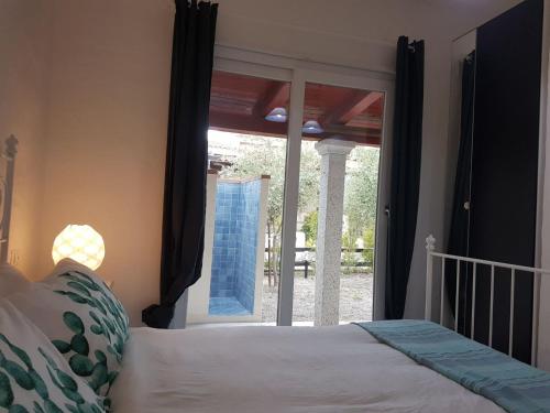 a bedroom with a bed and a sliding glass door at Ca' Viscomi in San Teodoro