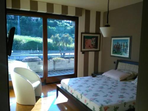 a bedroom with a bed and a sliding glass door at Villa Angela in San Benedetto del Tronto
