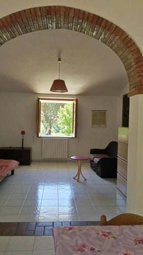 a living room with a table and a window at Agriturismo Collevento in Trecchina