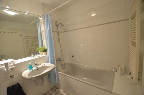 a bathroom with a tub and a sink and a shower at All-in-One in Berlin