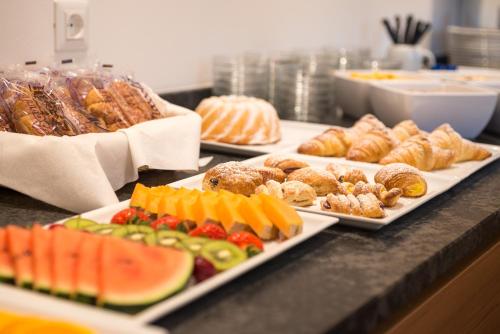 a buffet with several plates of food on a counter at Hotel Garni Herz in Tirolo