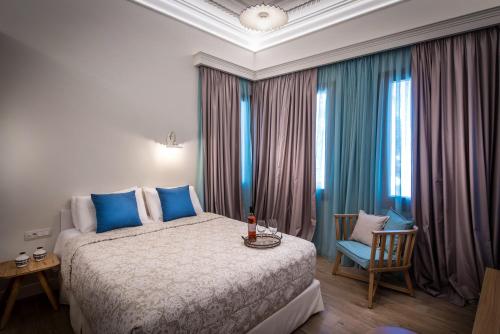 a bedroom with a large bed and a large window at Veneziano Boutique Hotel in Heraklio