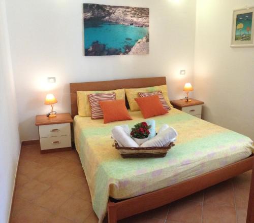 a bedroom with a bed with two night stands and two lamps at Appartamenti sul mare FRANCIS in Santa Cesarea Terme