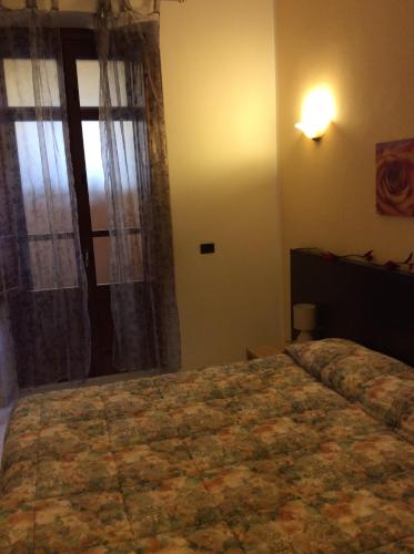 a bedroom with a large bed and a window at Alloggio privato Giunic in Cagliari