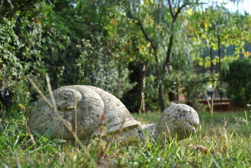 a statue of two animals laying in the grass at Sous L'Olivier in Menton