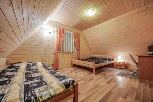 Postel nebo postele na pokoji v ubytování OW "Domki Matiaszówka" z PODGRZEWANYMI BASENAMI, kąpieliskiem ze zjeżdżalnią wodną, ogrodzonym placem zabaw i boiskiem