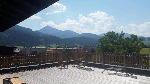 two chairs on a deck with a view of mountains at Haus Susanne in Radstadt