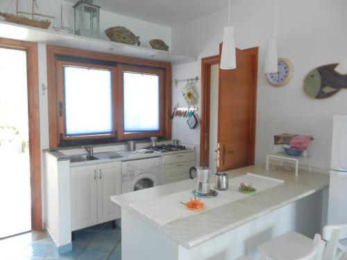 a kitchen with a sink and a washing machine at Villa Giglio Rosso in Campese