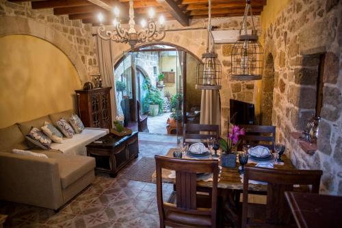 a living room with a table and a couch at George & Alexandra's Apartments in Rhodes Town