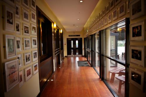 a hallway with pictures on the walls of a building at Da Vinci's Hotel in Derry Londonderry