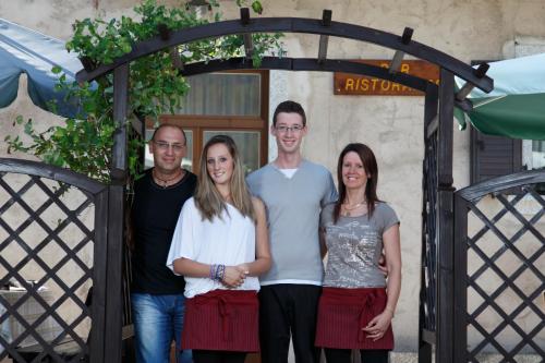a group of people standing in front of a gate at Albergo Casavecchia in Tiarno di Sopra