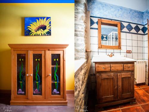 a bathroom with a sink and a cabinet with a mirror at Casa Rural Bango in Caboalles de Abajo