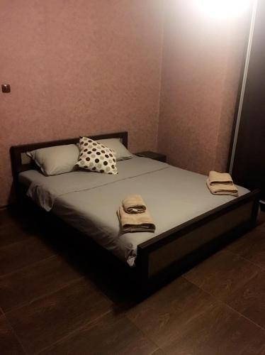 a bedroom with a bed with two towels on it at Guest House Pautalya in Kyustendil