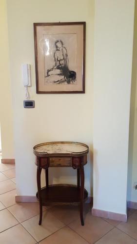 a table in a room with a picture on the wall at Casa vacanze Cristina in Imperia