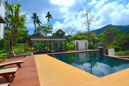 a house with a swimming pool in front of a house at The Bleu condo unit in Chaweng