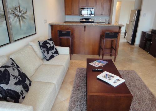 a living room with a couch and a table at Hotel La Vista Azul in Turtle Cove