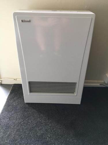 a white radiator sitting on the floor in a room at Mount View Motel Hawera in Hawera