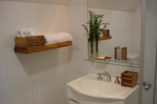 a white bathroom with a sink and a toilet at Sieteflores Hosteria De Montaña in San Martín de los Andes