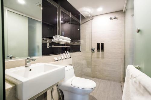 a bathroom with a sink and a toilet and a shower at Manhattan Business Hotel Damansara Perdana in Petaling Jaya