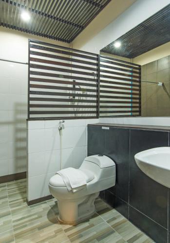 a bathroom with a toilet and a sink at Krabi Home Town Boutique in Krabi town