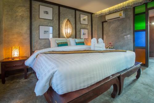 Voodi või voodid majutusasutuse Rainforest ChiangMai Hotel toas