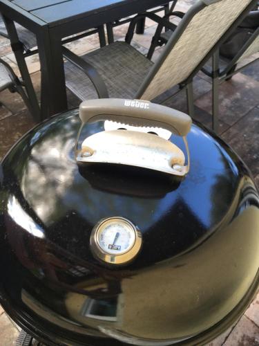 a clock sitting on top of a table next to a chair at Ferienwohnung Sailer in Bruck an der Mur