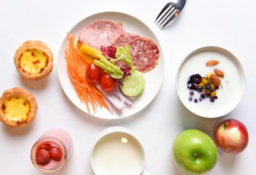 a white table with plates of food on it at Futian Shangri-La, Shenzhen,Near to Shenzhen Convention&Exhibition Centre, Futian Railway Station in Shenzhen