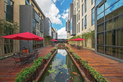 a patio with tables and chairs and a koi pond at Best Boutique Hotel in Nanhui