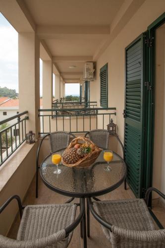 a table with a plate of food on a balcony at Guest House Medin in Petrovac na Moru