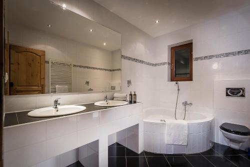 a bathroom with two sinks and a toilet at Chata Adamec in Ždiar