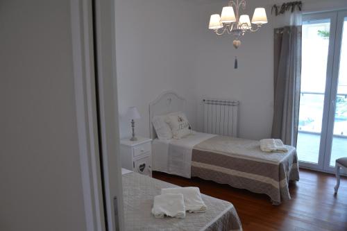 Voodi või voodid majutusasutuse Porto Nuovo Holiday Home toas